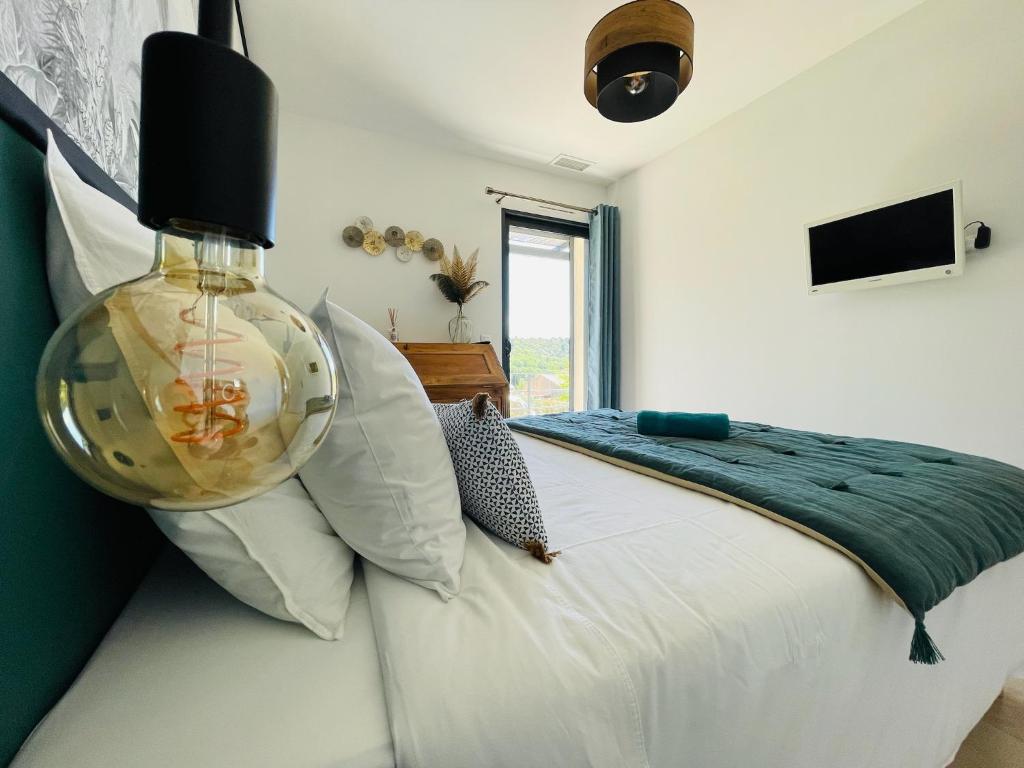 a bedroom with a bed with a fish bowl on it at Gite La Madeleine du Luberon. in Lioux