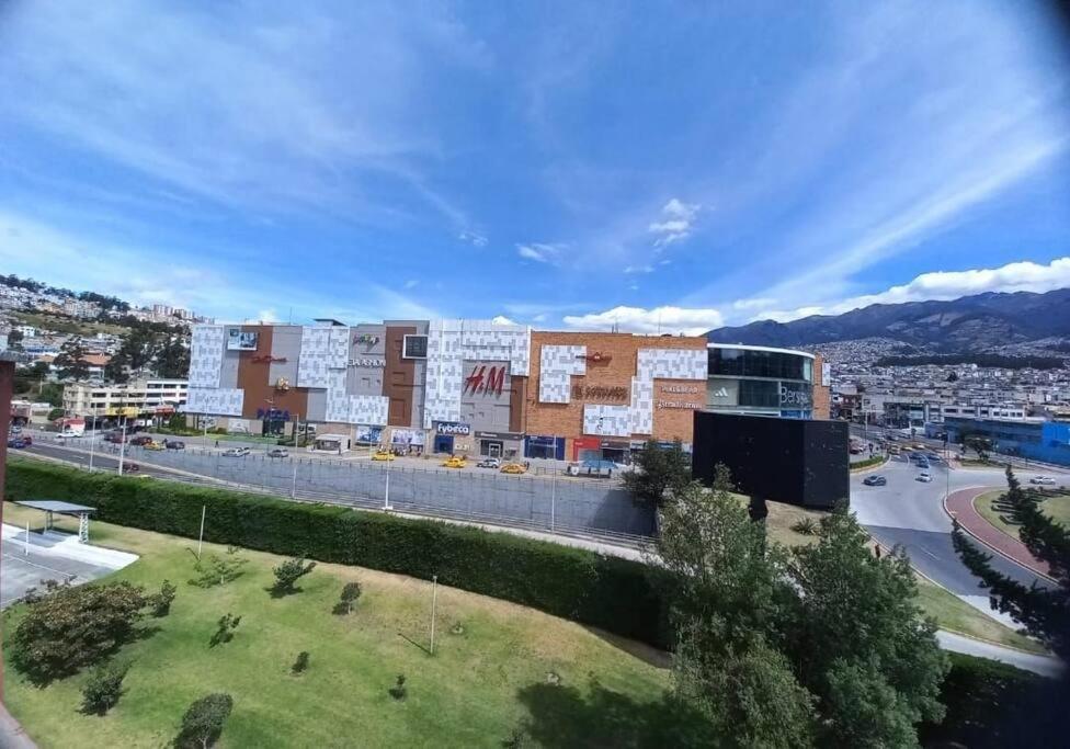 a large building in a city with a street at Departamento con jacuzzi 5 piso Condado 2 habitaciones in Quito