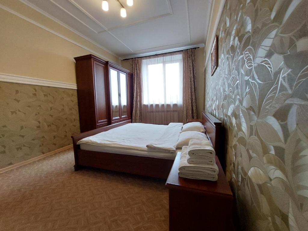 a small bedroom with a bed and a window at Двокімнатні апартаменти у центрі in Lutsk