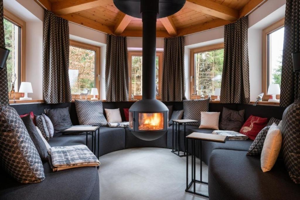 a living room with couches and a fireplace at Tolles Ferienhaus in Wagrain Hofmark mit Offenerem Kamin in Wagrain