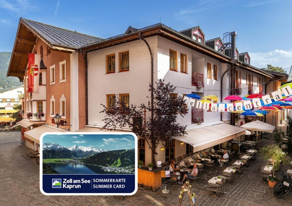 an image of a building with a banner in front of it at Cella Central Historic Boutique Hotel in Zell am See