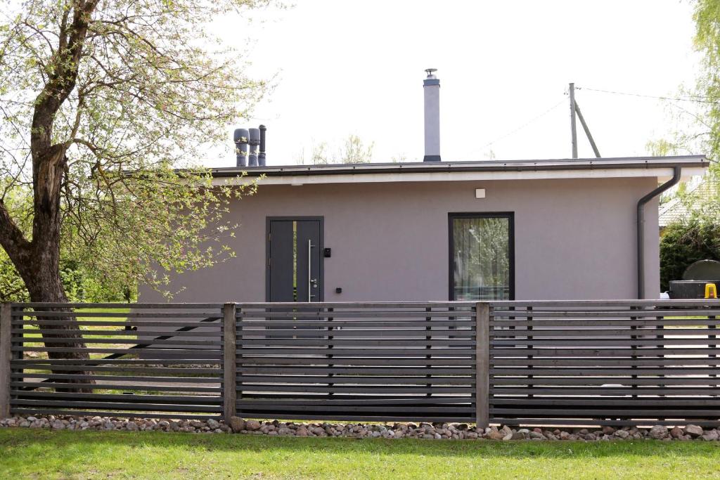 a house with a fence in front of it at Tūristu apartamenti in Sigulda