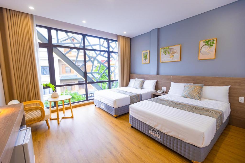 Postel nebo postele na pokoji v ubytování Tropic Bloom Hotel