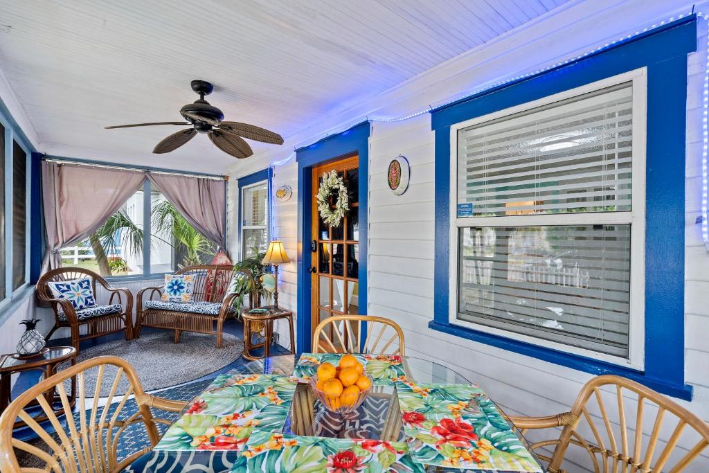 a dining room with a table and chairs and a ceiling fan at The Pineapple Bungalow St Pete in St Petersburg