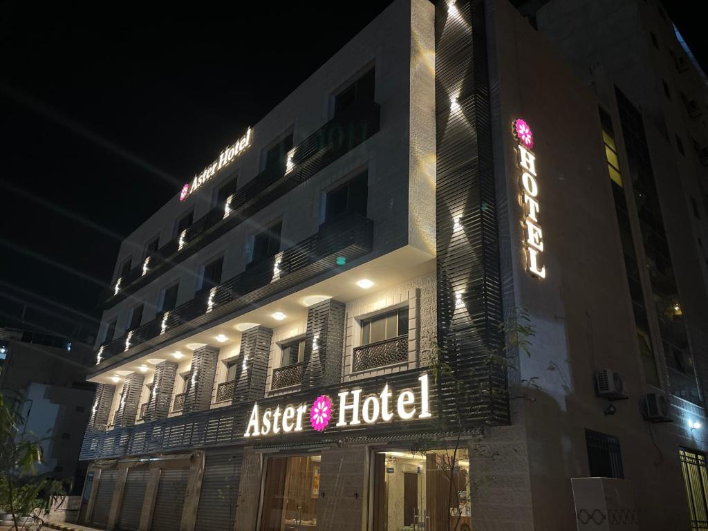 a hotel with a sign that reads asset hotel at night at Aster Hotel Aqaba in Aqaba