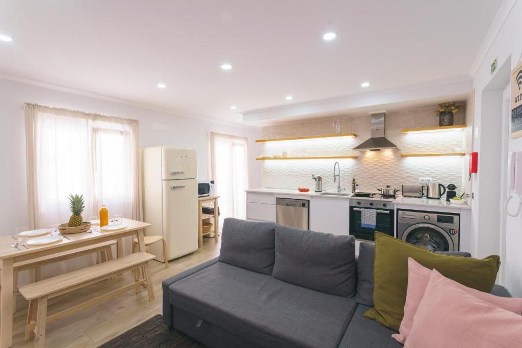 a living room with a couch and a kitchen at Best Houses 102 - Hut Spot Peniche in Peniche
