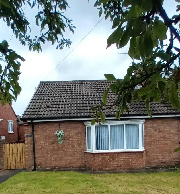 a brick house with a window and a fence at Bungalow in Shildon County Durham in Shildon