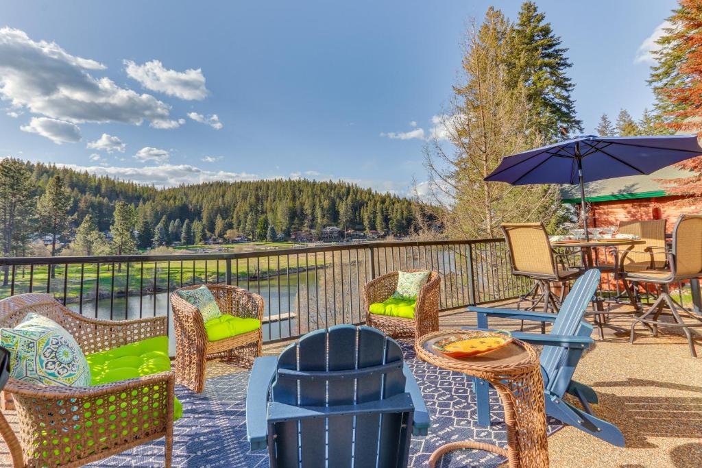 a patio with chairs and a table and an umbrella at Lakefront Coeur dAlene Home with Deck and Shared Dock in Coeur d'Alene