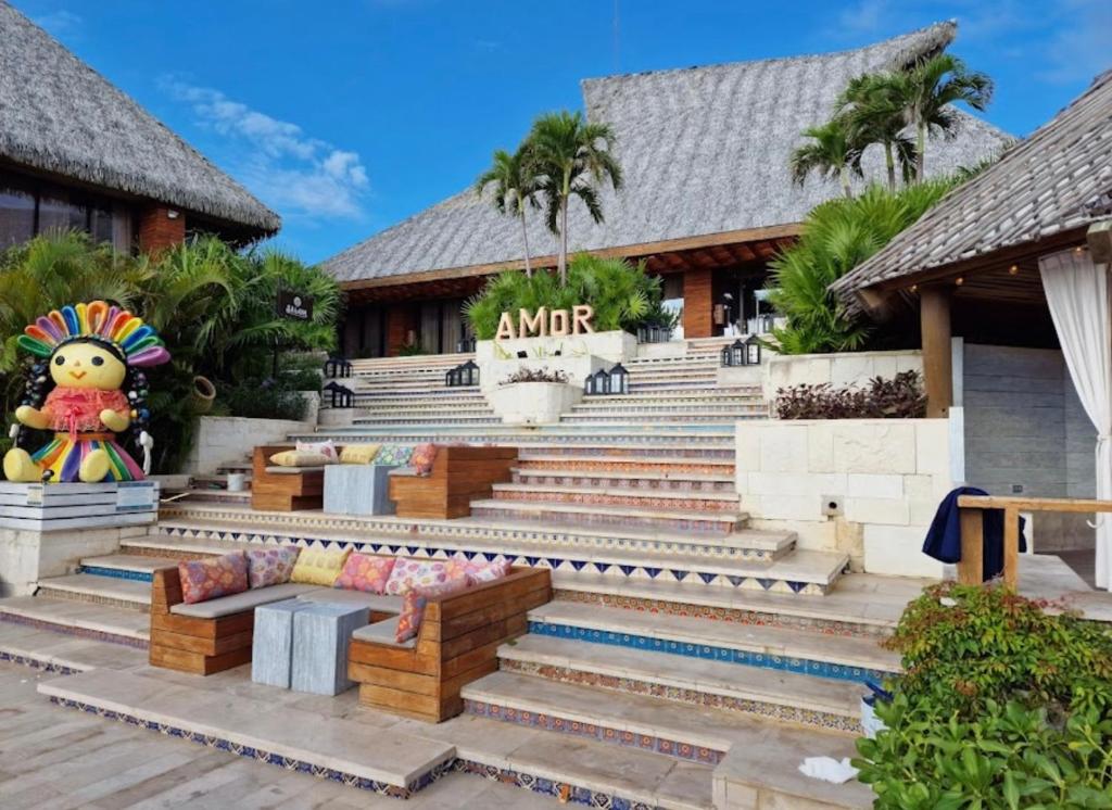 a resort with stairs and a sign that reads aunt at Vidanta Riviera Maya in Puerto Morelos
