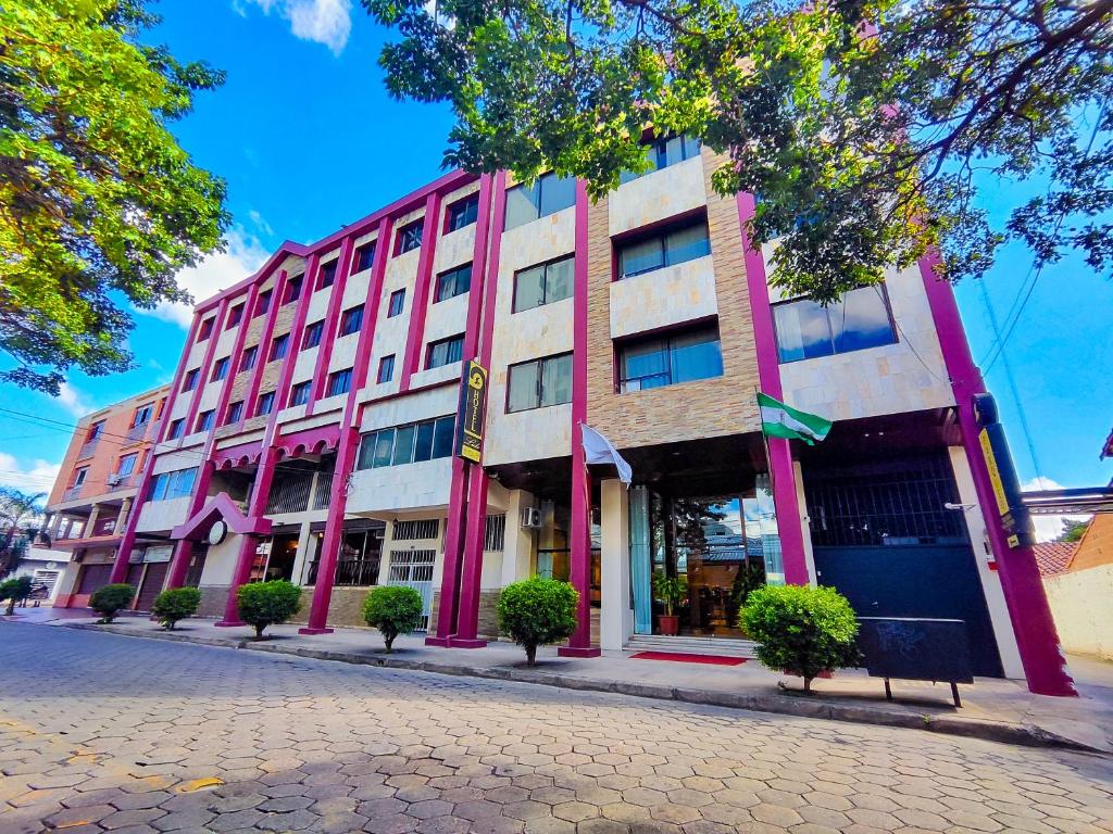 a pink and white building on a city street at Hotel Lido in Santa Cruz de la Sierra