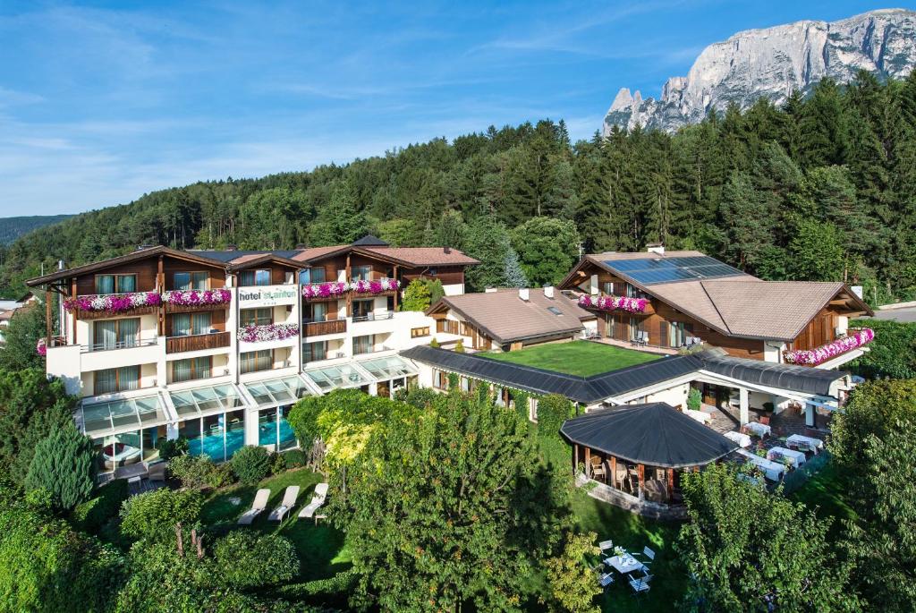 an aerial view of a hotel in the mountains at Hotel St. Anton in Völs am Schlern