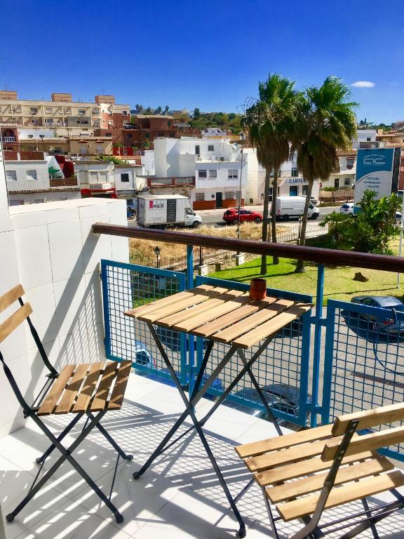 a table and chairs on a balcony with a view of a city at Casa Bulgari in Tarraguilla