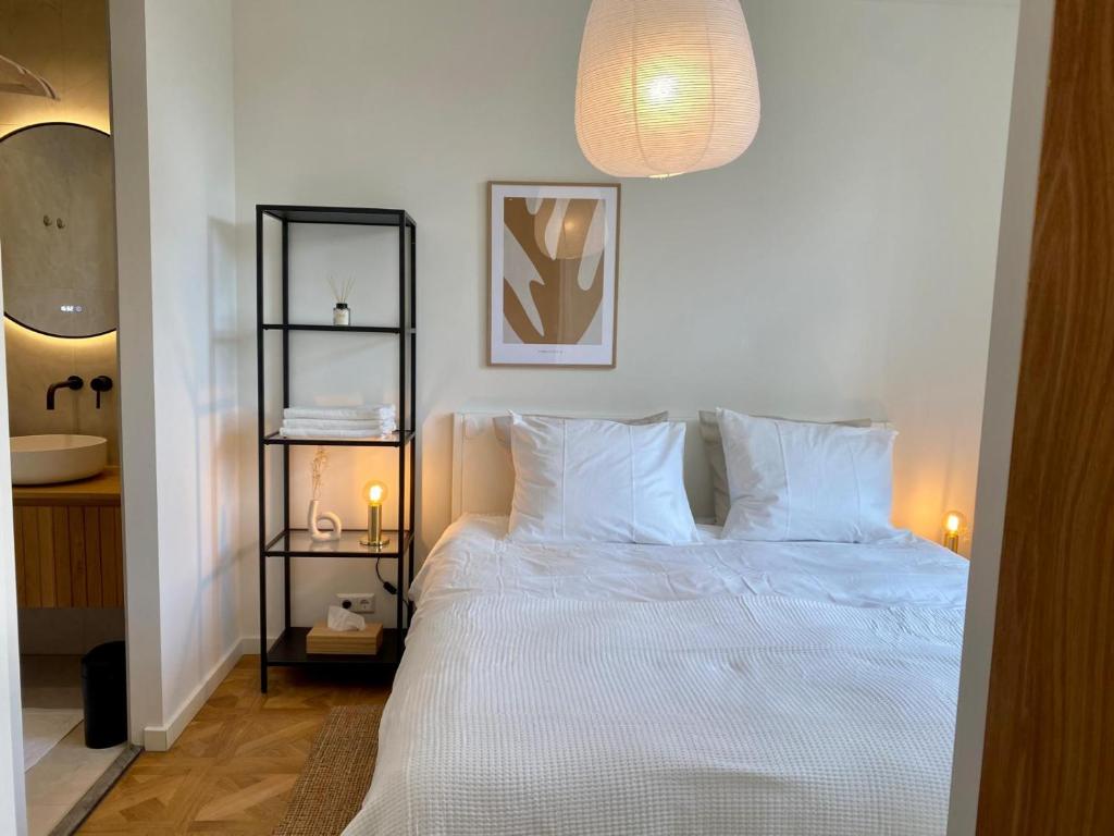 1 dormitorio con 1 cama blanca y 2 almohadas blancas en Luxury room with private bathroom on great location. en Ámsterdam
