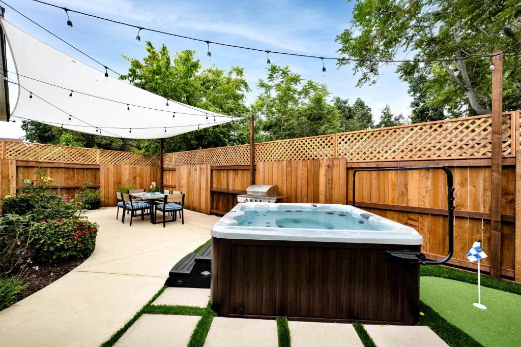 a backyard with a hot tub in a yard at Retro Cottage, Hot Tub, Putting Green, walk to all in Thousand Oaks