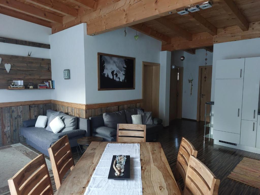 a living room with a table and a couch at Apart Lechtraum in Stanzach