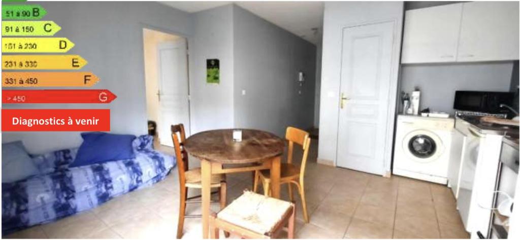 Appartement part dieu في ليون: مطبخ مع طاولة وكراسي في غرفة
