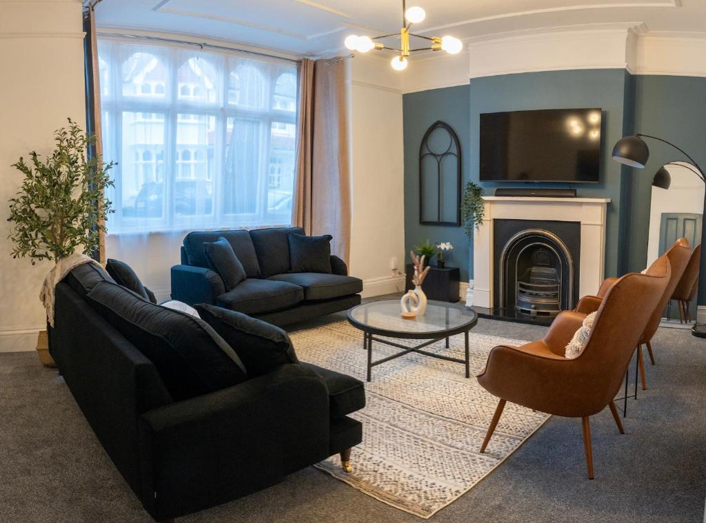 a living room with two couches and a fireplace at Chiswick 4 Bed Victorian Townhouse Minutes to Tube in London