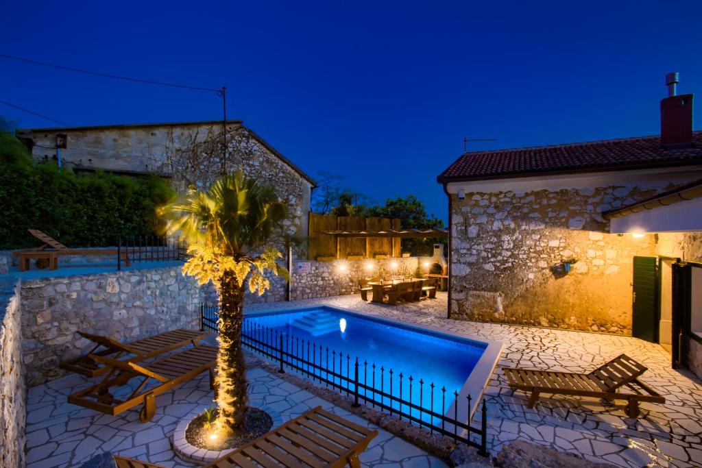 a villa with a swimming pool at night at Villa Kirica in Bribir
