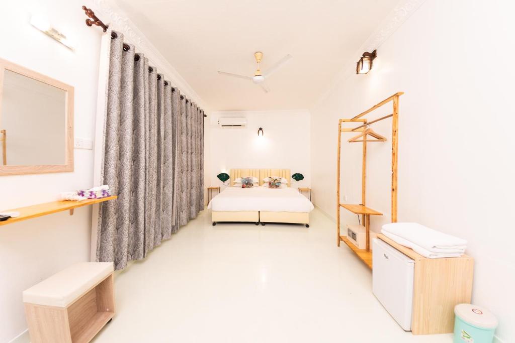 Postel nebo postele na pokoji v ubytování Fasdheythere Inn Maldives