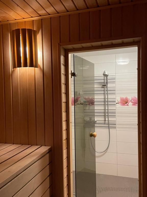 a bathroom with a shower with a glass door at Baltic retreat house in Ventspils