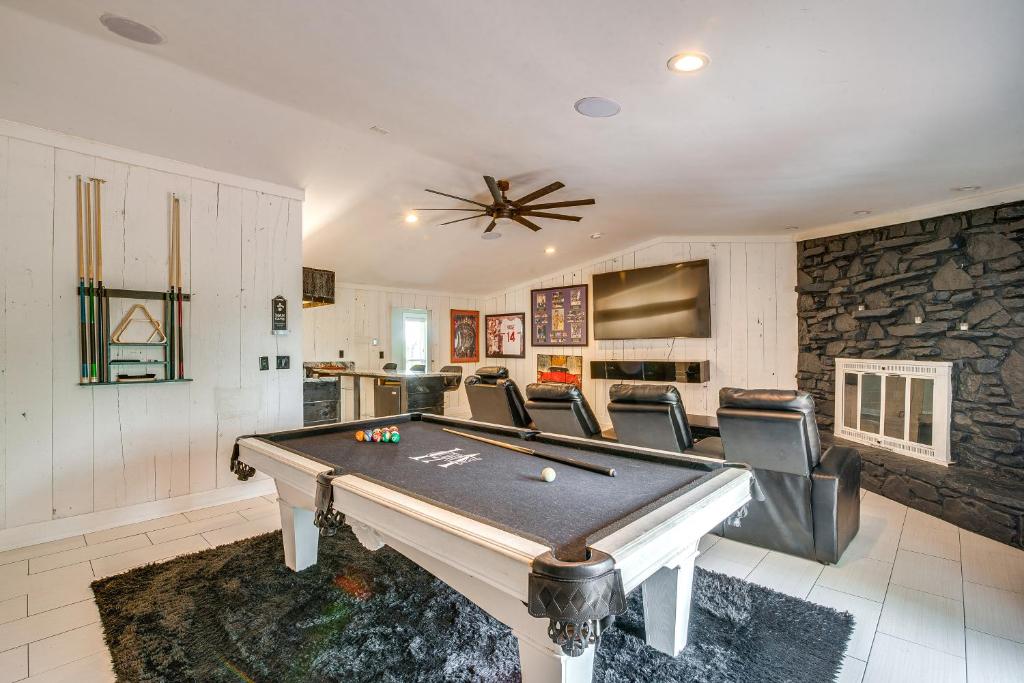 a living room with a pool table and chairs at Spacious Bowling Green Home with Hot Tub and Pool! in Bowling Green