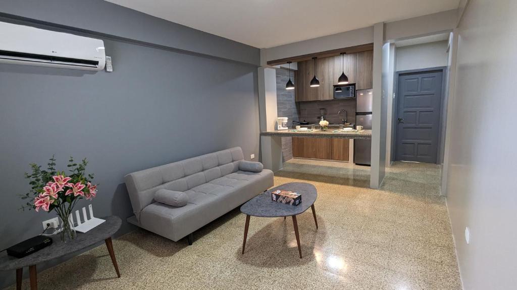 a living room with a couch and a table at Suite 618 Downtown Guayaquil- Centro de la Ciudad in Guayaquil