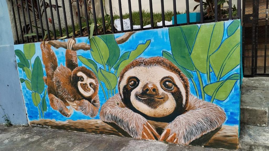 a painting of two sloths on a wall at Casa Escalante Hostel in San José