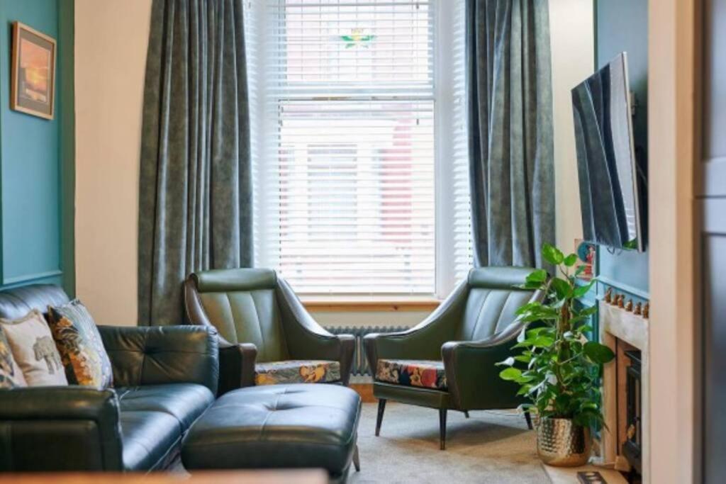 a living room with a couch and chairs and a window at Home away from home in Liverpool