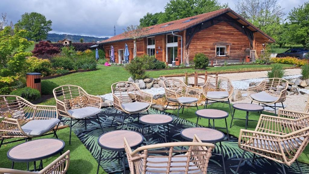 a group of chairs and tables in front of a house at Le Paradis, chambres d'hôtes - BNB- Gîte in La Roche-sur-Foron