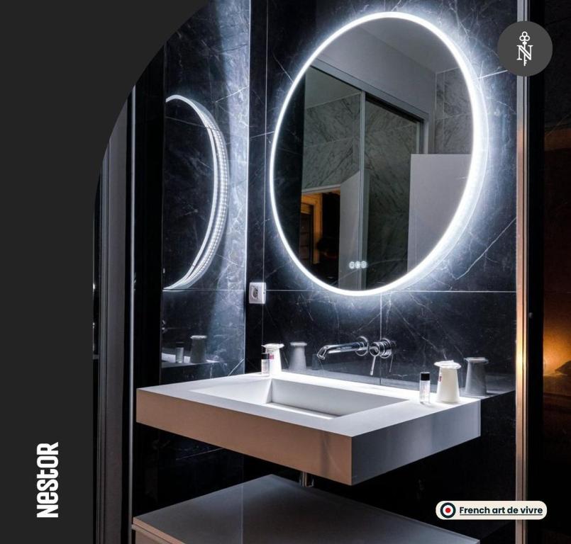a bathroom with a sink and a mirror at La Casa Verde - View of the racecourse & meadow in Caen