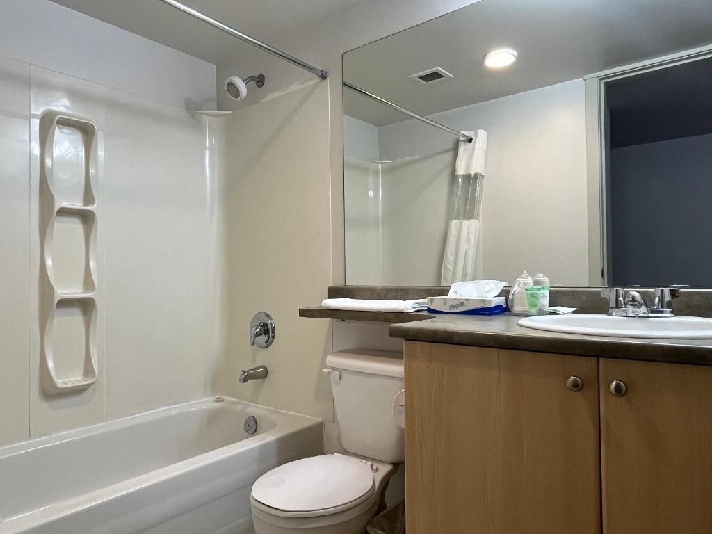 a bathroom with a toilet and a sink and a tub at Carey Centre on UBC campus in Vancouver