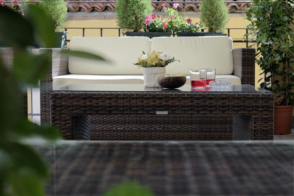 a patio with a chair and a table with candles at Hotel American-Dinesen in Venice