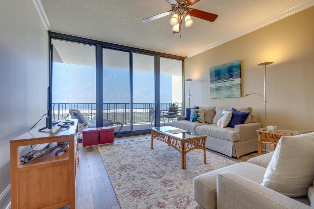 a living room with a couch and a table at Beachfront Dauphin Island Condo with 2 Pools and Sauna in Dauphin Island