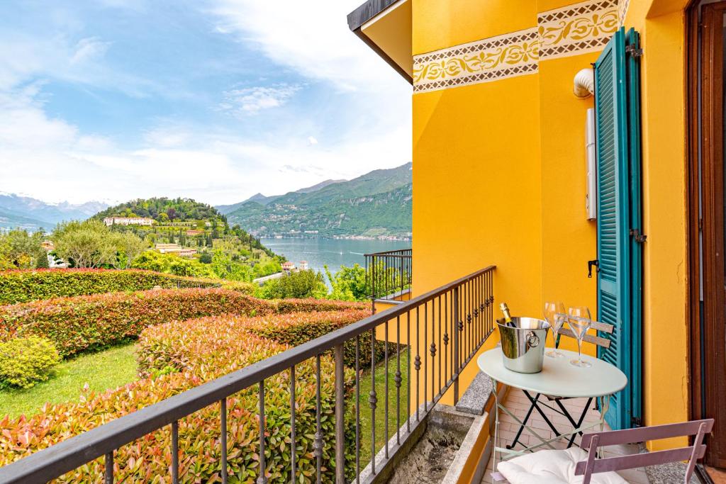a balcony with a table and a view of the water at Pearl Of The Lake apartment, Bellagio, breathtaking views and good vibes in Bellagio