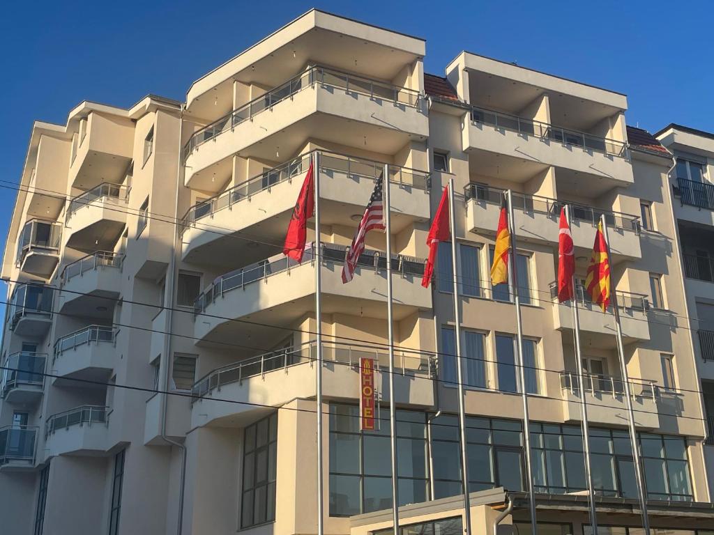 a building with flags in front of it at Hotel Majestic in Struga