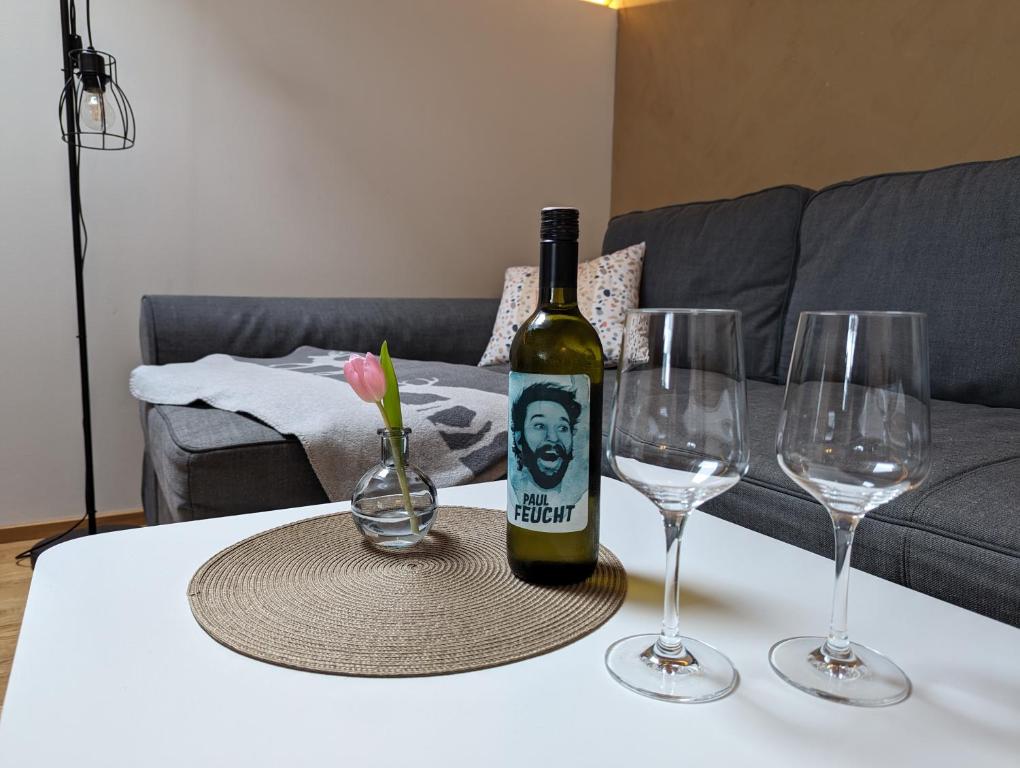 a bottle of wine sitting on a table with two wine glasses at Auszeit in Buch