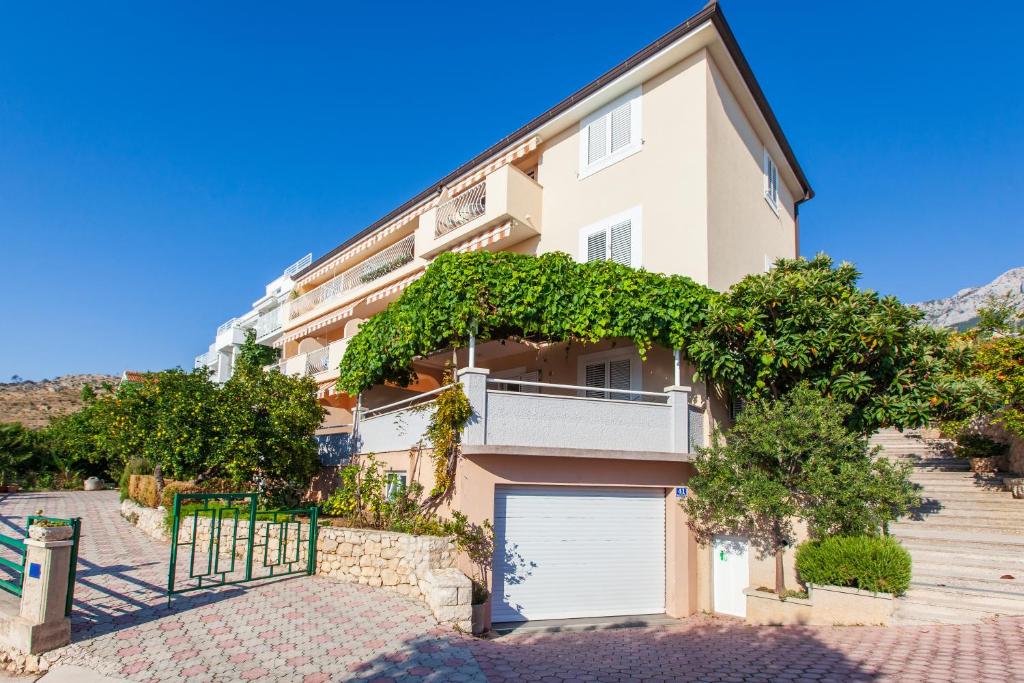 a large apartment building with a garage at Podgora apartment no.5 in Podgora
