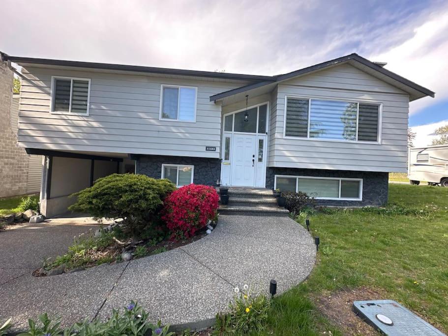 a house with a white door and a driveway at Sabrina's Home in Delta