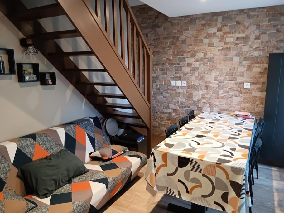 une chambre avec une table, un lit et un escalier dans l'établissement Le duplex de Dana, Gresse en Vercors, Alpes du Nord, classement 3 étoiles par Atout France, à Gresse-en-Vercors