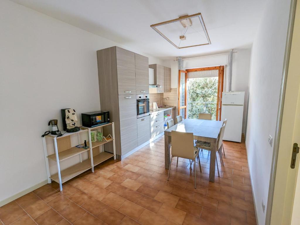 a kitchen and dining room with a table and chairs at Il granchio in Marcelli