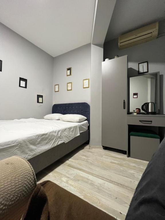 a bedroom with two beds and a desk in it at Red sophia suites in Istanbul