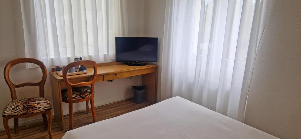 TV a/nebo společenská místnost v ubytování Beau Rivage