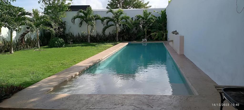 a swimming pool in the backyard of a house at Casa Dzitya in Mérida