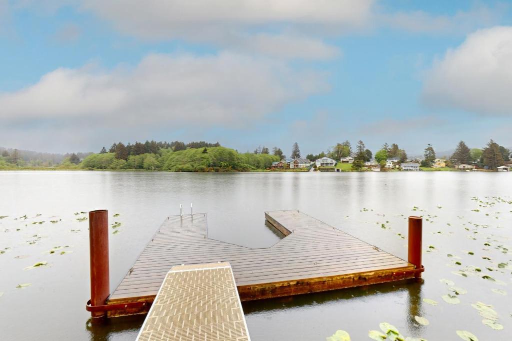 a dock in the middle of a lake at Lazy Lookout on Devils Lake in Lincoln City