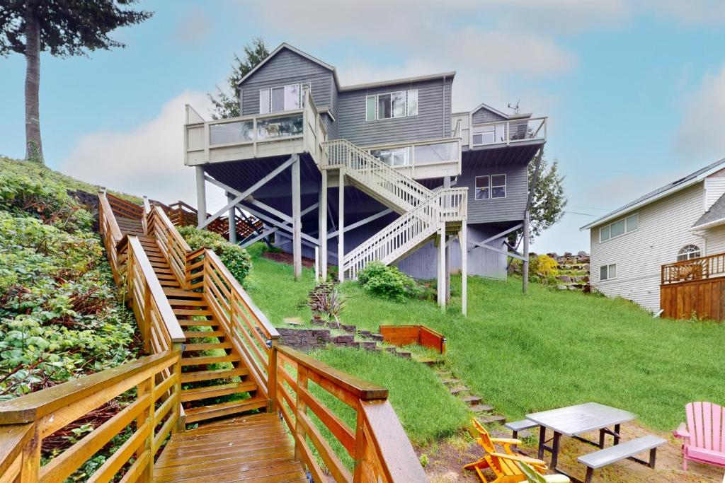 a house on a hill with stairs leading up to it at Lazy Lookout on Devils Lake in Lincoln City