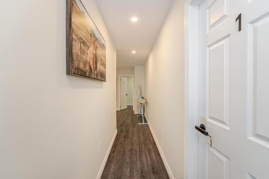 a hallway with a door and a painting on the wall at Private basement bedrooms in Oakville in Oakville