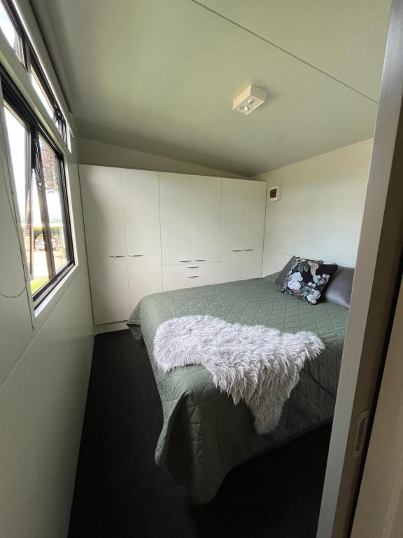 a bedroom with a bed and a window at Suite Ten10 in Te Awamutu