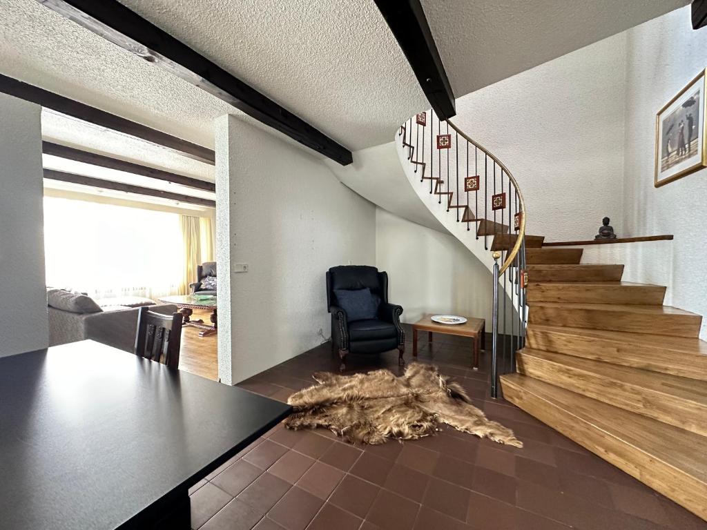 a living room with a table and a staircase at House in Reykjavik - Birta Rentals in Reykjavík