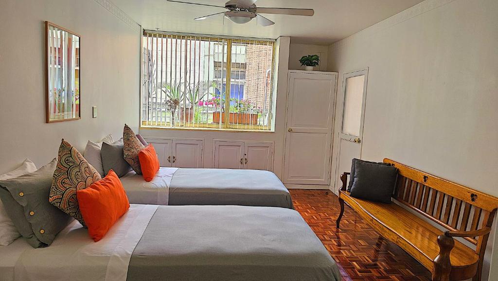 a bedroom with two beds and a window at Apto con terraza privada junto al Bulevar del Rio y Calle del Sabor in Cali