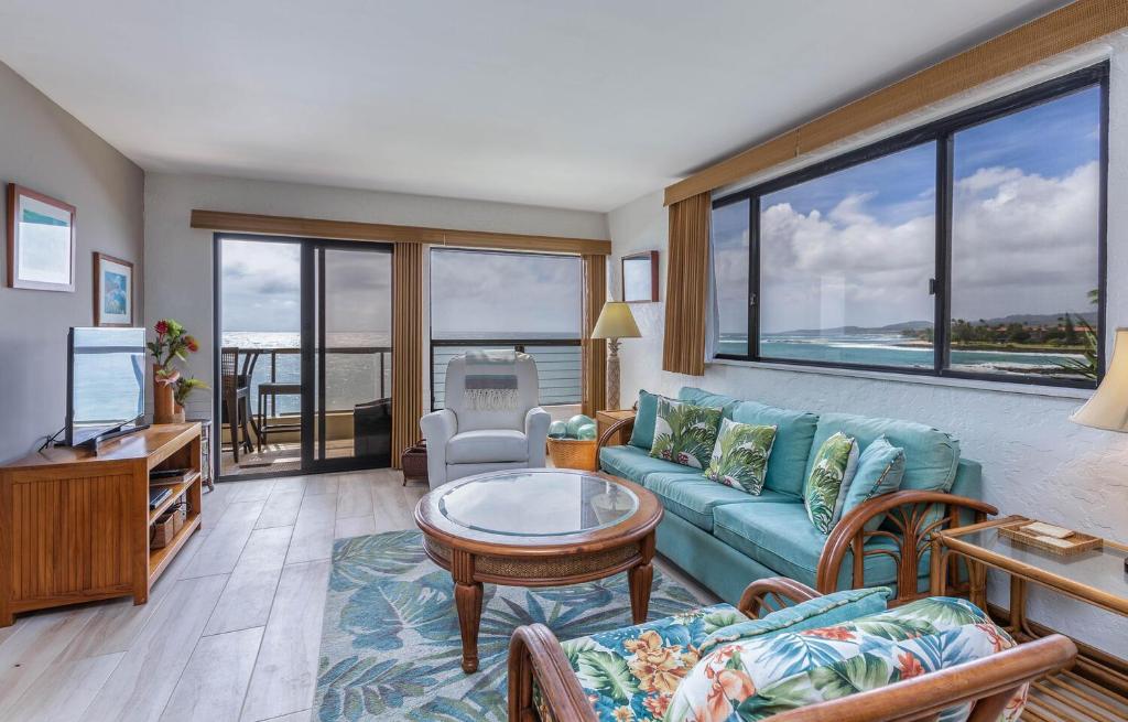 a living room with a couch and a table at Poipu Shores 207A in Koloa